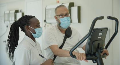 a physio monitoring a patient on an exercise bike